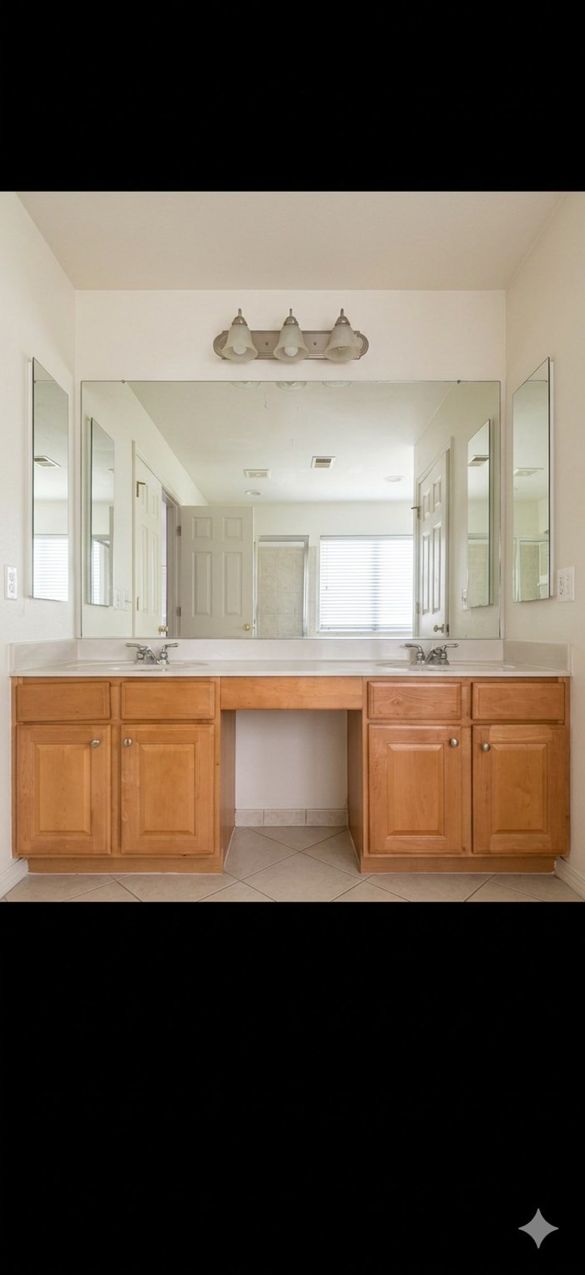 Before, dated double vanity with oak cabinets